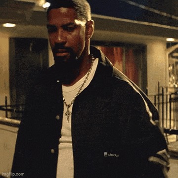 a man wearing a black jacket that says clocko