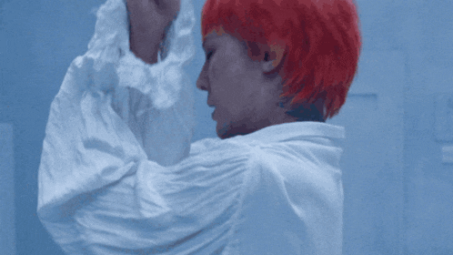 a man with red hair and a white shirt
