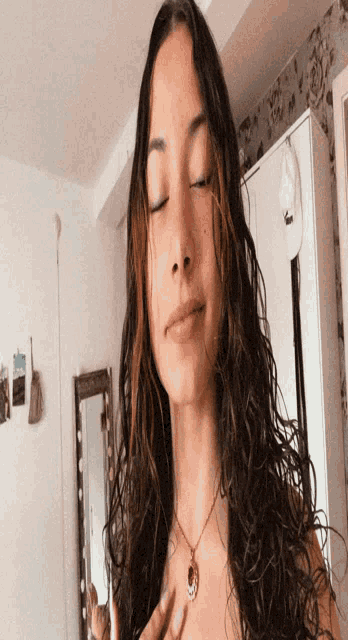 a woman with curly hair is taking a selfie