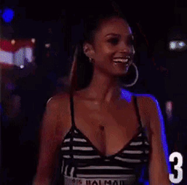 a woman in a striped top has the number three on her arm