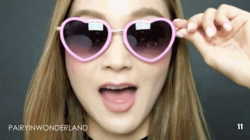 a close up of a woman wearing heart shaped sunglasses with the caption pairyin wonderland