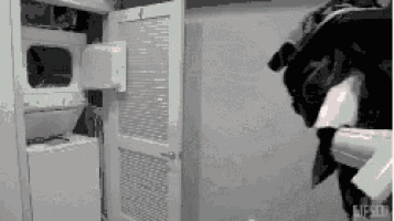 a black and white image of a laundry room with a washer and dryer