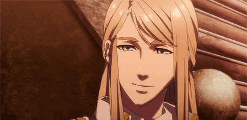 a man with long blonde hair is smiling and looking at something
