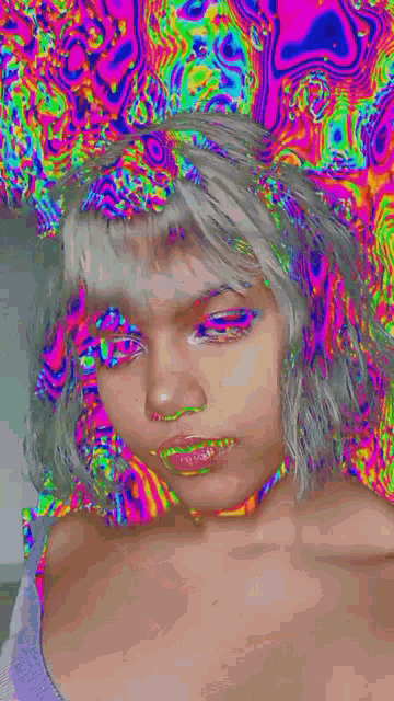 a girl with white hair and a colorful background is taking a selfie .