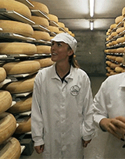 a woman wearing a white lab coat with the word holland on it stands next to a man