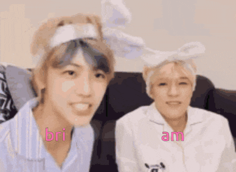 two boys wearing bunny ears are sitting next to each other on a couch