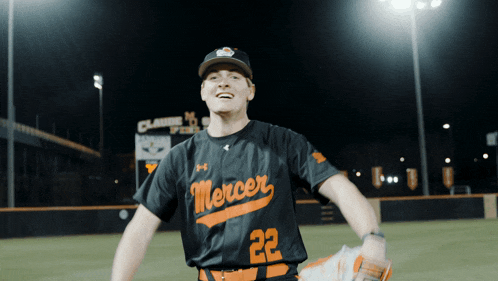 a baseball player wearing a mercer jersey stands on the field