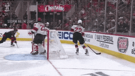 a hockey game is being played in front of a sign that says cheerwine