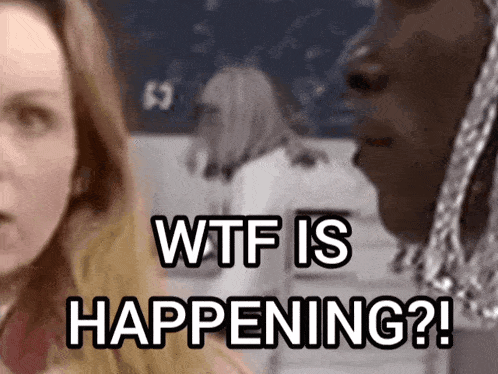 a woman in a classroom says wtf is happening in front of a man