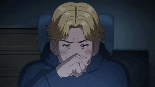 a man with blonde hair is covering his face with his hands
