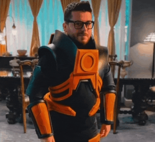 a man wearing glasses and a black and orange suit with a large o on the chest