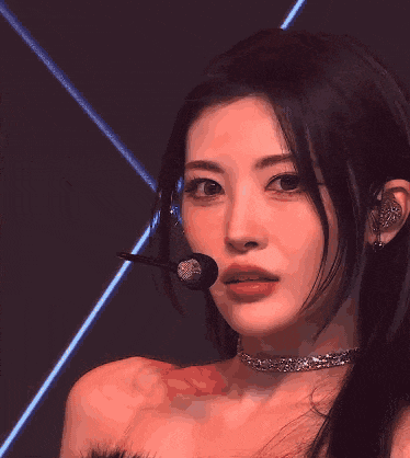 a close up of a woman wearing a choker and earbuds