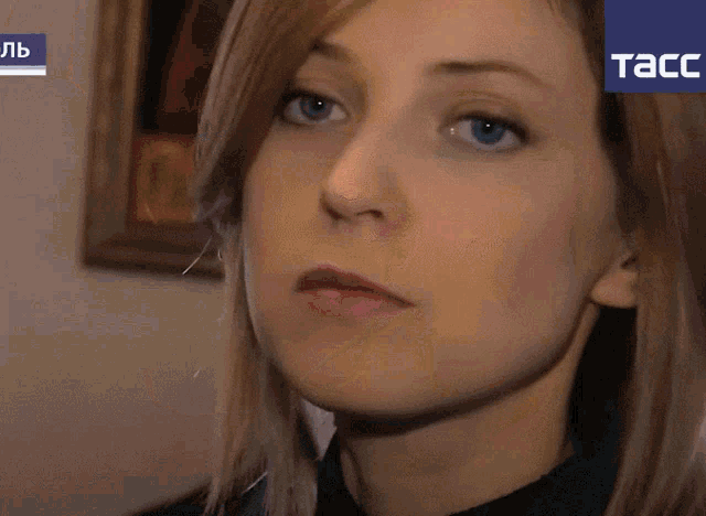a close up of a woman 's face with a tacc logo in the corner