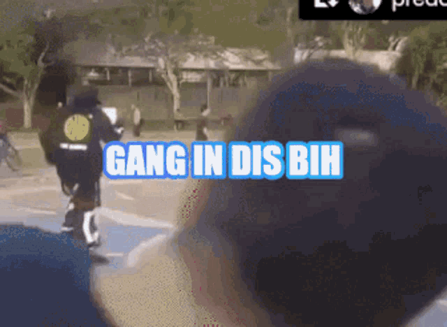 a person riding a bike with the words gang in dis bih written on the screen