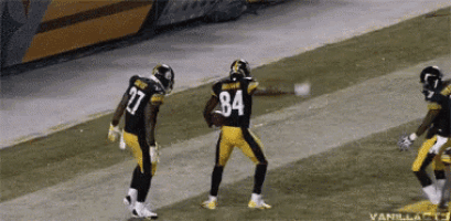 a football player with the number 84 on his jersey stands on the field
