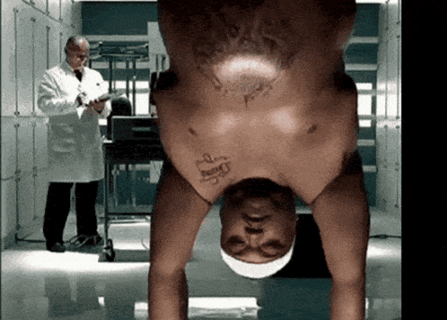 a man is upside down with a tattoo on his chest that says " penny "