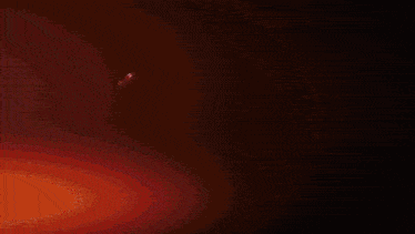 a glowing red object with a winged design on it