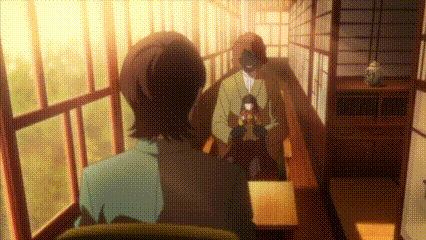 a man and a woman are standing in a hallway looking out the window .