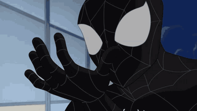 a close up of a black spider man 's face and hands
