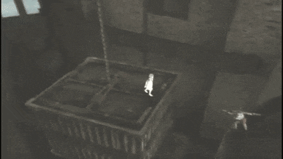 a person is hanging from a chain in a dark room in a video game