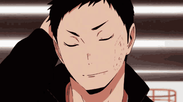 a man with his eyes closed holds his hand to his head