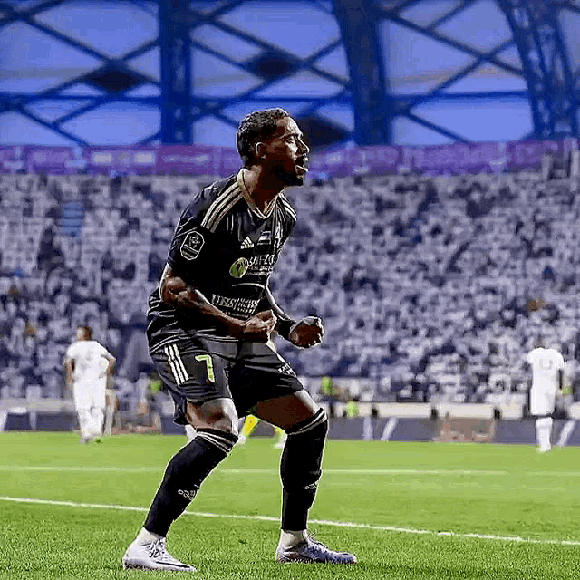 a soccer player with the number 7 on his jersey is celebrating