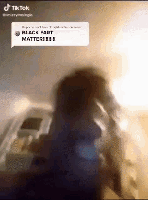 a blurred image of a person with a speech bubble saying black fart matter