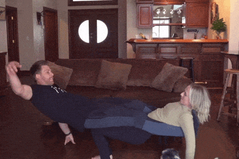 a man and a woman are doing exercises on a couch