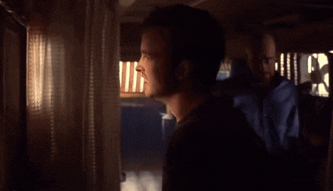 a man looking out a window with the word bitch written in white letters