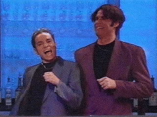 two men are standing next to each other in front of a blue background .