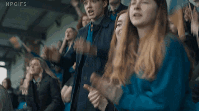 a group of people applauding with npgifs on the bottom