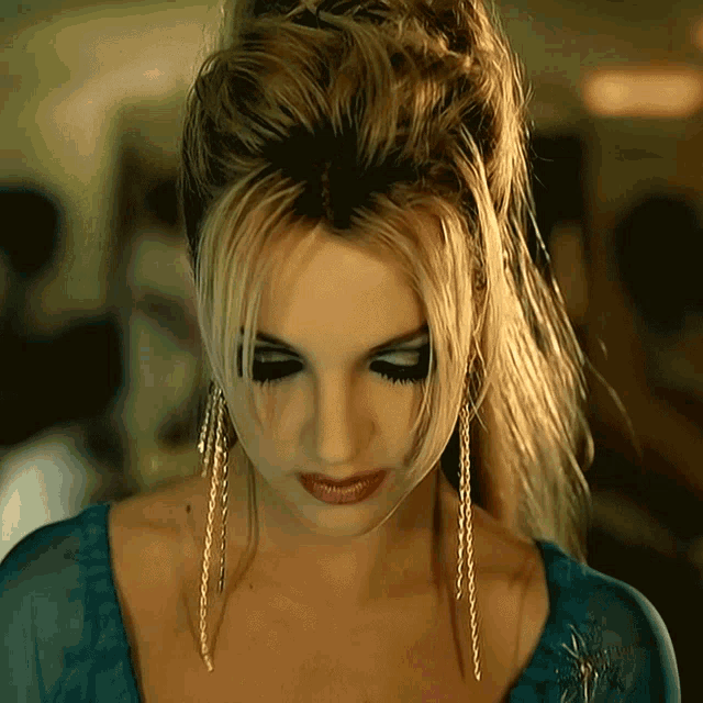 a close up of a woman wearing a blue shirt