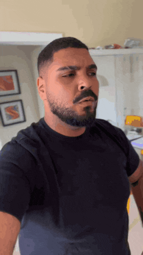 a man with a beard wearing a black shirt