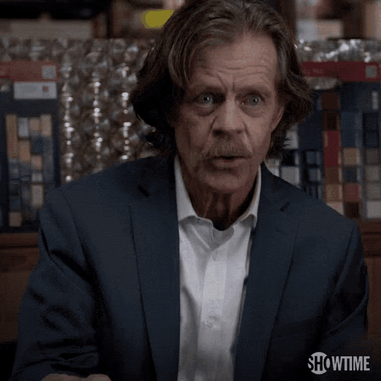 a man in a suit and white shirt is pointing and says whoa