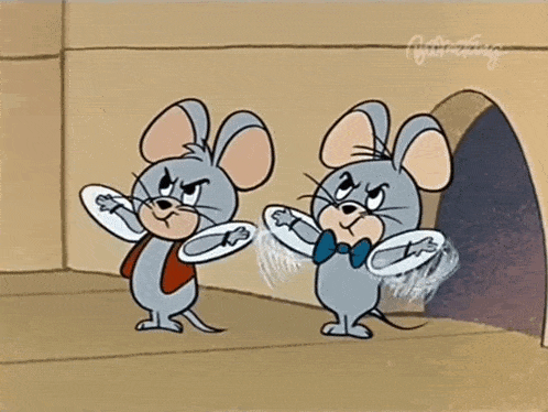 two cartoon mice are standing next to each other in front of a hole in a wall