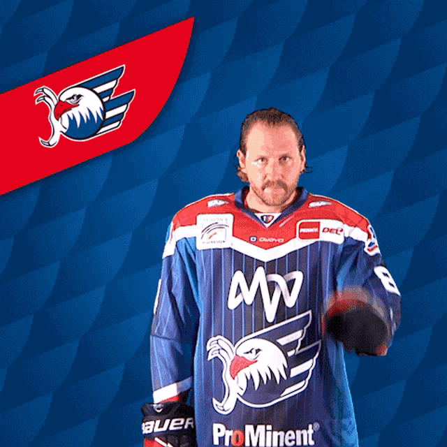 a man is wearing a blue and red jersey that says mw on it