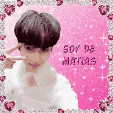 a boy is taking a picture of himself in a pink frame with the words soy de matias written on it .