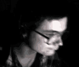 a man wearing glasses and headphones looks at the camera