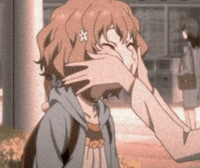 a girl with a star in her hair is covering her face with her hand