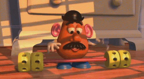 mr potato head from toy story is lifting a barbell on a wooden floor