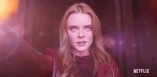 a close up of a woman 's face with a netflix logo in the background