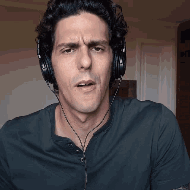 a man wearing headphones and a black shirt