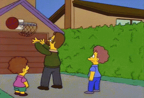 a man with a mustache is holding a basketball and talking to two children