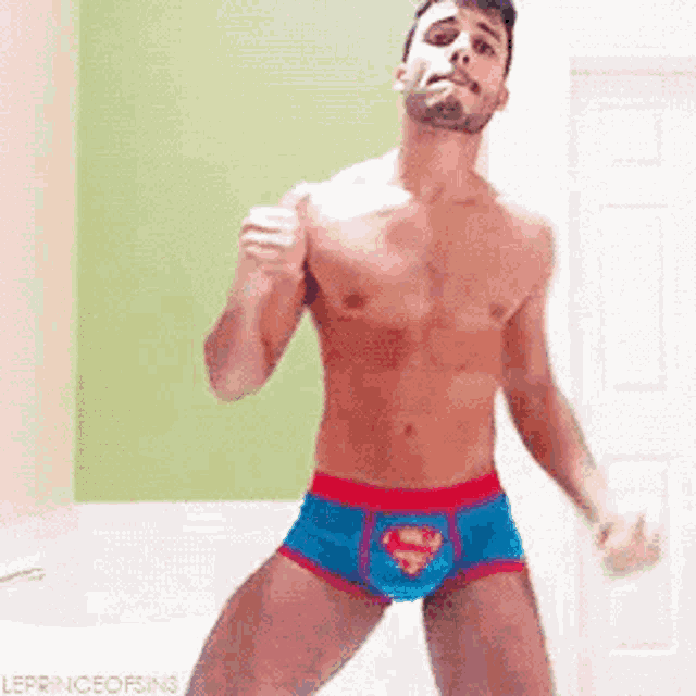 a shirtless man is dancing in his underwear .