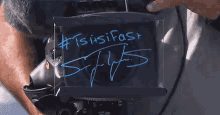 a person is holding a piece of paper that says tsisifast on it