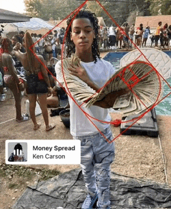 a young man is holding a bunch of money in his hands .