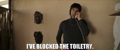 a man talking on a phone with the words " i 've blocked the toiletry " written below him