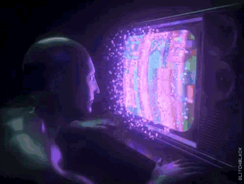 a man is sitting in front of a television with purple lights coming out of the screen .