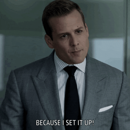 a man in a suit and tie is saying " because i set it up "