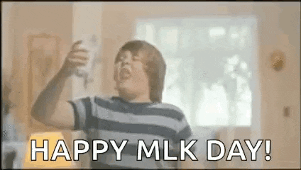 a boy is holding a bottle of milk in his hand and shouting happy mlk day .